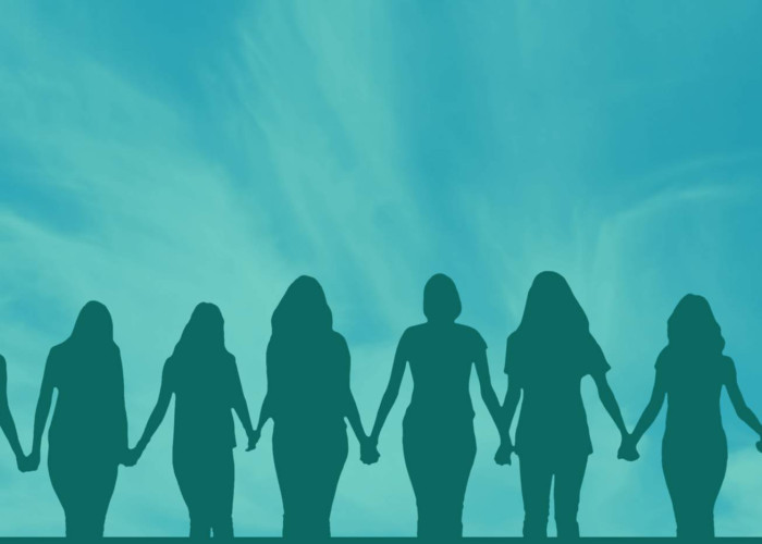 Silhouettes of women holding hands against a blue sky.