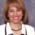 A woman with brown hair and red lipstick.