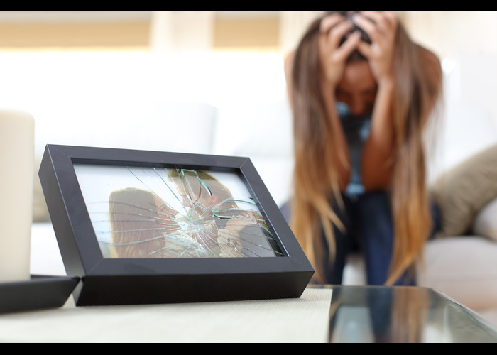 A woman sitting in front of a picture frame.