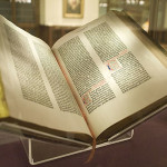 Open book with gold-leaf edges on display.