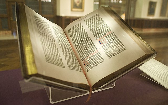 Open book with gold-leaf edges on display.