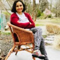 A woman sitting in a chair on the ground